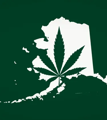Cannabis leaf centered inside a white silhouette of Alaska on a dark green background.